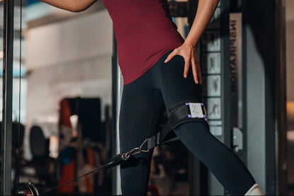 Person exercising on a cable machine in a gym setting