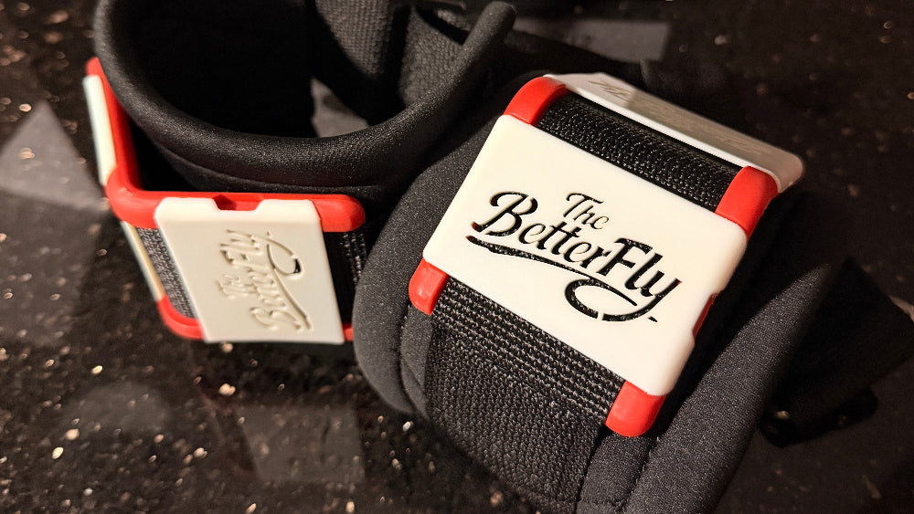Close-up of a black and red fishing fly box with 'The Better Fly' branding on a dark background.
