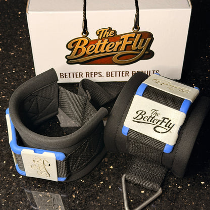 Black wrist straps with blue accents and 'The BetterFly' branding on a dark surface.