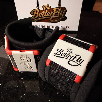 Black and red wrist wrap with 'The Better Fly' branding on a dark surface.