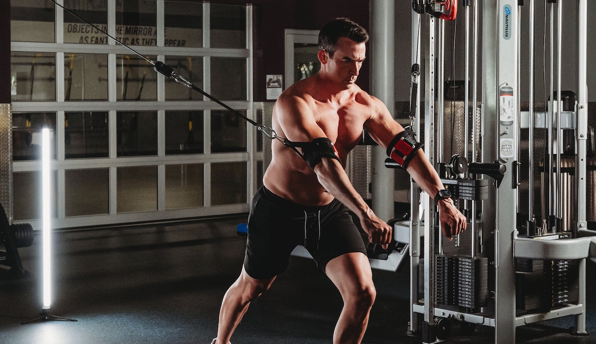 Muscular man exercising in a gym setting